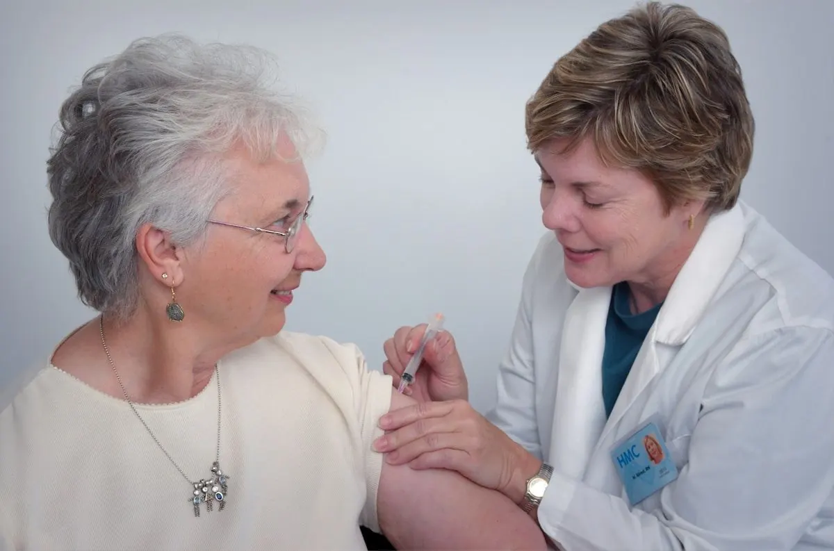 Home health nurse caring for a senior client during a visit
