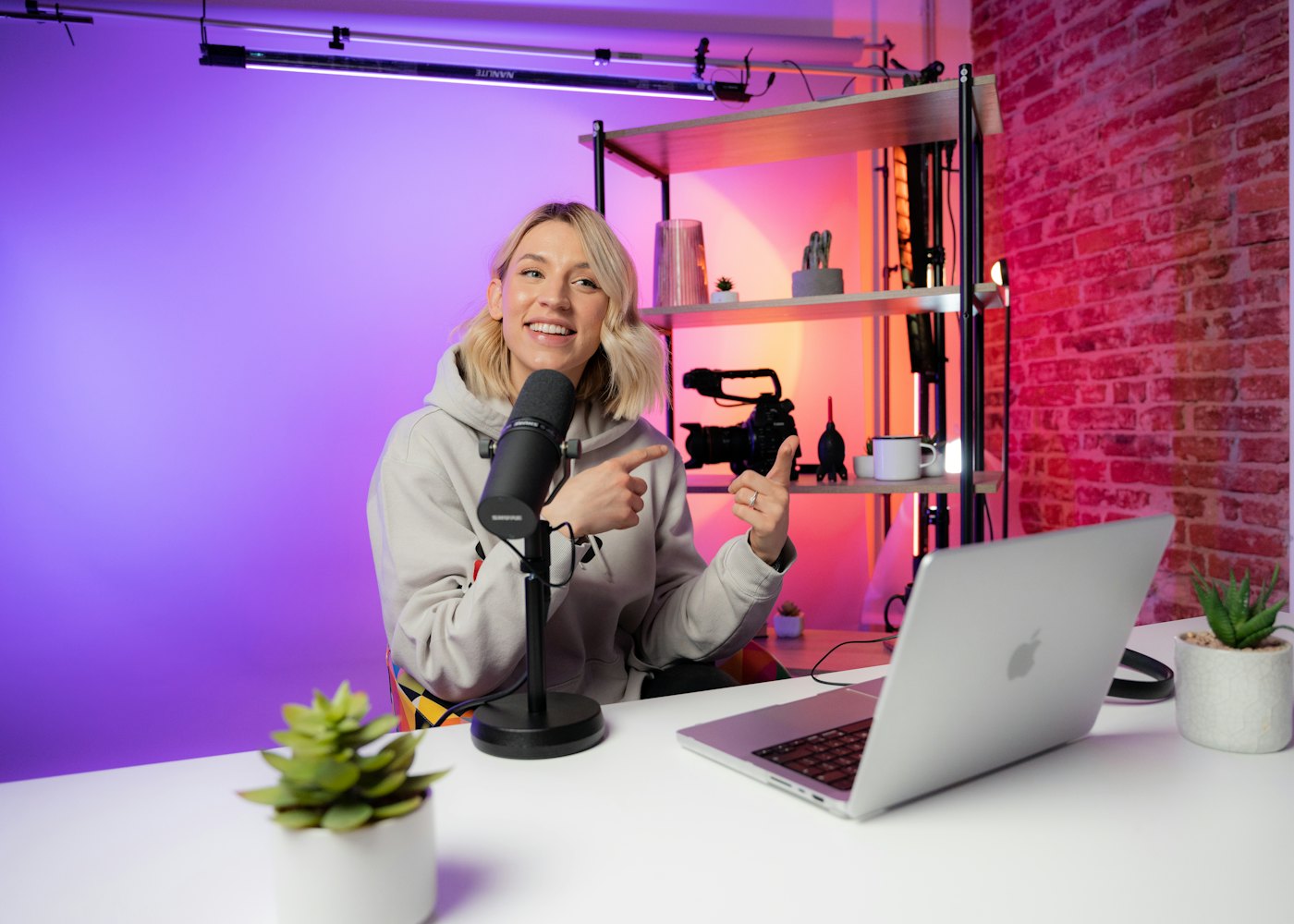 Online course creator recording a lesson with a microphone and laptop