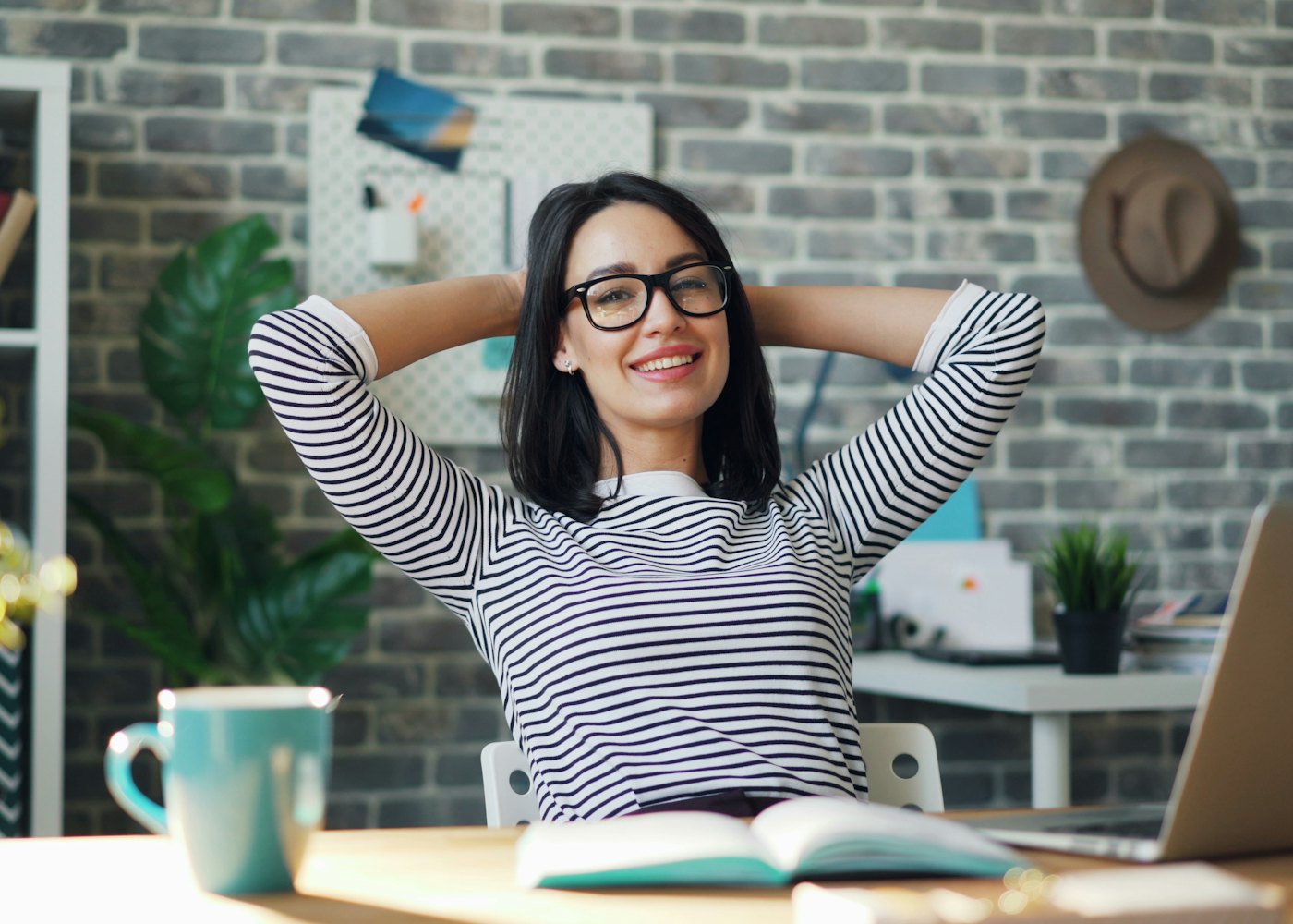 Relieved business owner relaxing at her desk after resolving an IRS notice